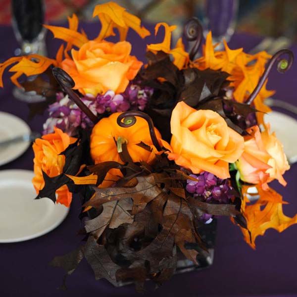 a centerpiece of dramatic dark leaves and pops of orange and purple flowers are the perfect - Halloween Centerpieces Wedding a centerpiece of dramatic dark leaves and pops of orange and purple flowers are the perfect - Halloween Centerpieces Wedding