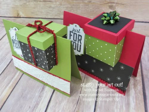 two gift boxes with bows and tags on them