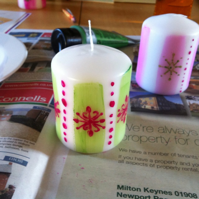 Two Candles Sitting On Top Of A Newspaper Two Candles Sitting On Top Of A Newspaper