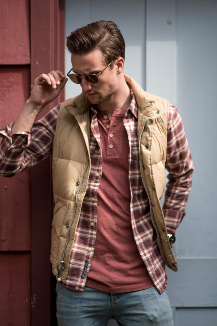 Tan puffer vest + plaid button down + red henley shirt + light wash