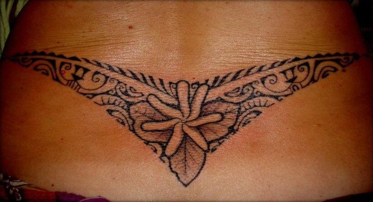 on Lower Back of Maori Polynesian style for Women representing a “v” or boomerang with a flower and leaves in the center and the wings fullfilled with multiple ancient symbols from the Traditional Marquesas’s Ancient TATAU. Designed & Tattooed by Manao Tiki Tattoo Toulon on Lower Back of Maori Polynesian style for Women representing a “v” or boomerang with a flower and leaves in the center and the wings fullfilled with multiple ancient symbols from the Traditional Marquesas’s Ancient TATAU. Designed & Tattooed by Manao Tiki Tattoo Toulon
