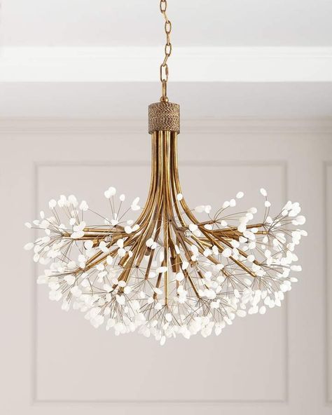 a chandelier with white flowers hanging from it's ceiling fixture in a room