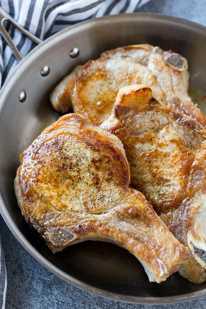 Browned bone in pork chops in a frying pan. | Brown sugar pork chops ...