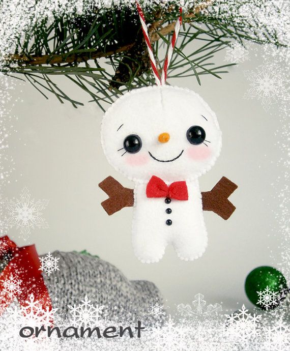 a snowman ornament hanging from a christmas tree