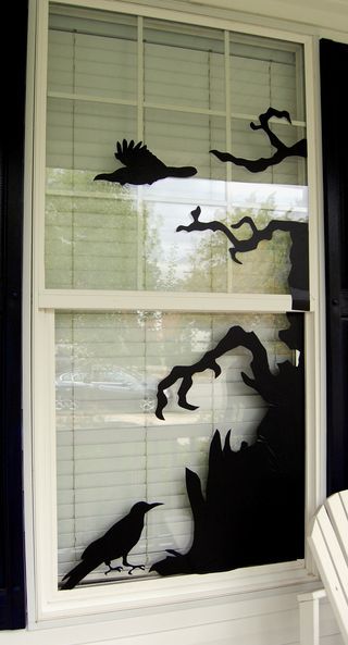 i do this with black construction paper and an exacto knife tape paper together for halloween window displayhalloween window decorationshalloween