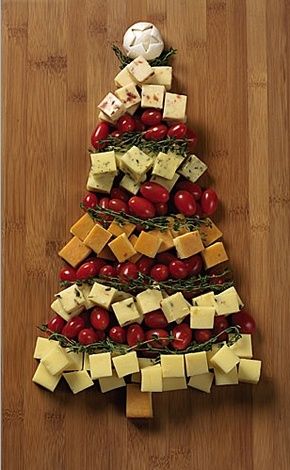 a christmas tree made out of cheese and tomatoes