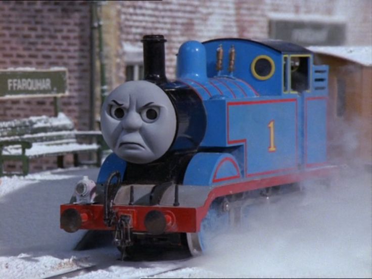 a thomas the tank engine train traveling through snow