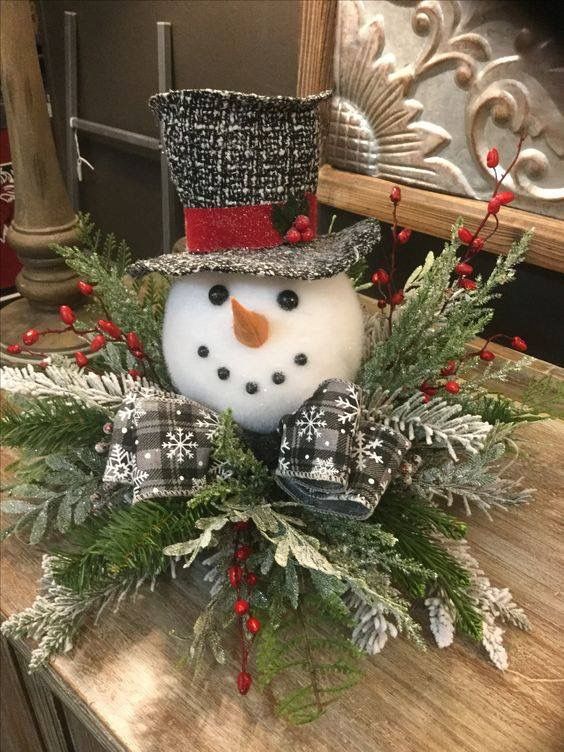 a snowman sitting on top of a wooden table