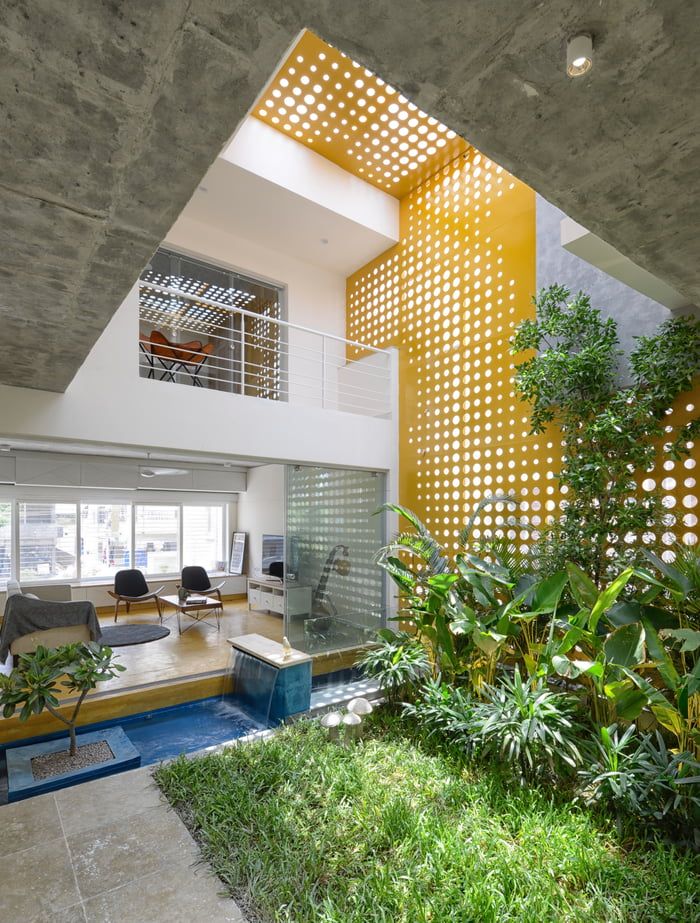 Double height living spaces around the central indoor courtyard garden and pond ...