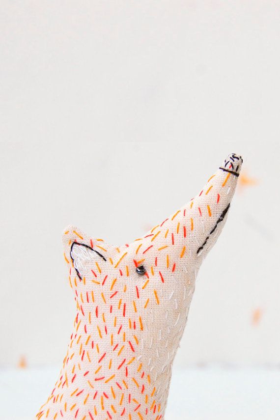 A smart stitched fox. It is as big as a palm and hand-stitched. This may be a a ...