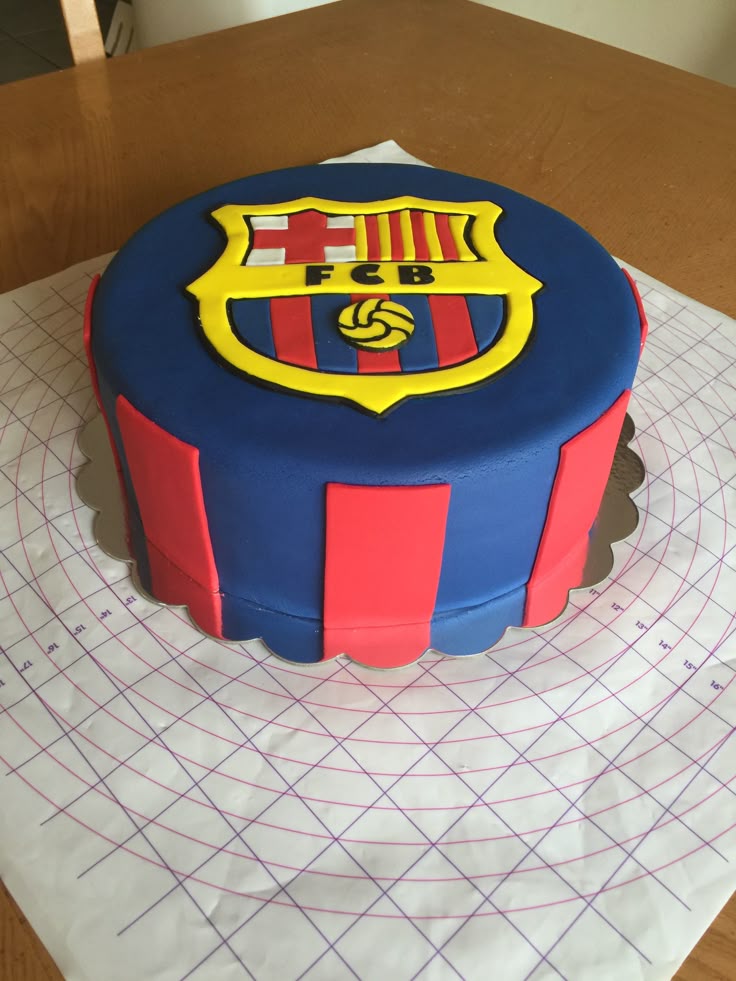 a cake that is sitting on top of a piece of paper and has a soccer