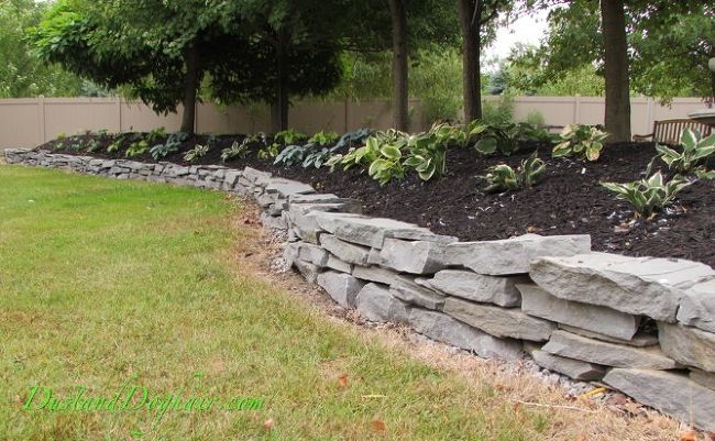 Build A Stacked Stone Garden Wall Stone Landscaping Stacked Stone Walls Stone Walls Garden