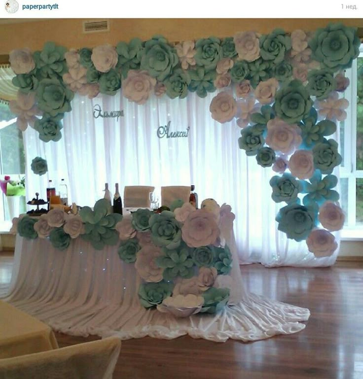 the table is set up with flowers on it