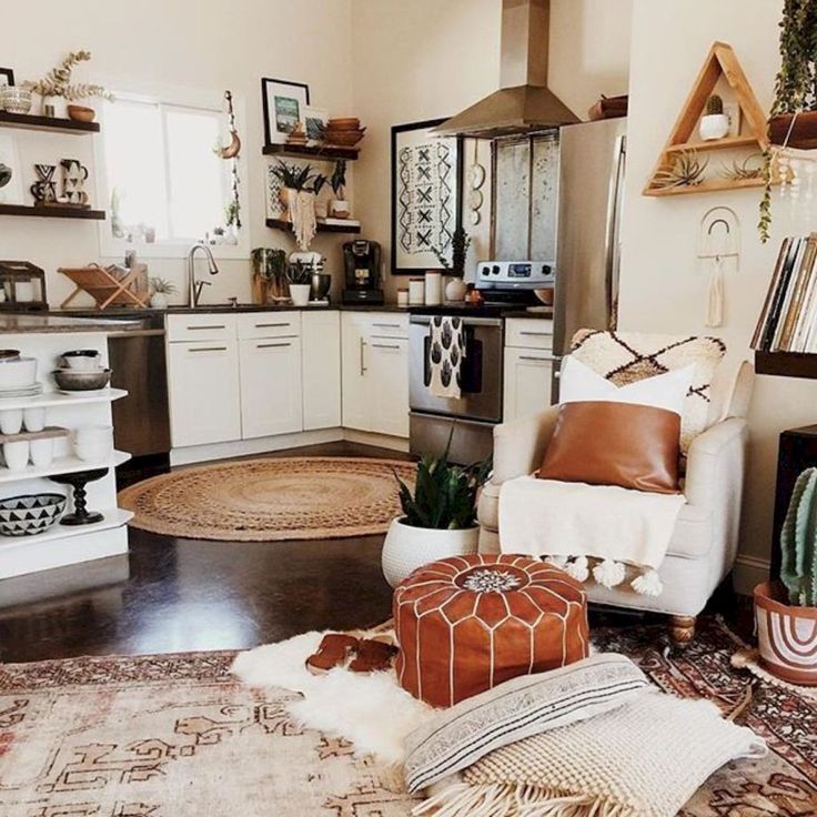 a living room filled with lots of furniture and decor on top of a hard wood floor