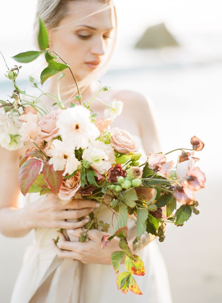 Closeup Shot Of Bride Holding Bouquet At Beach Planned By Honour