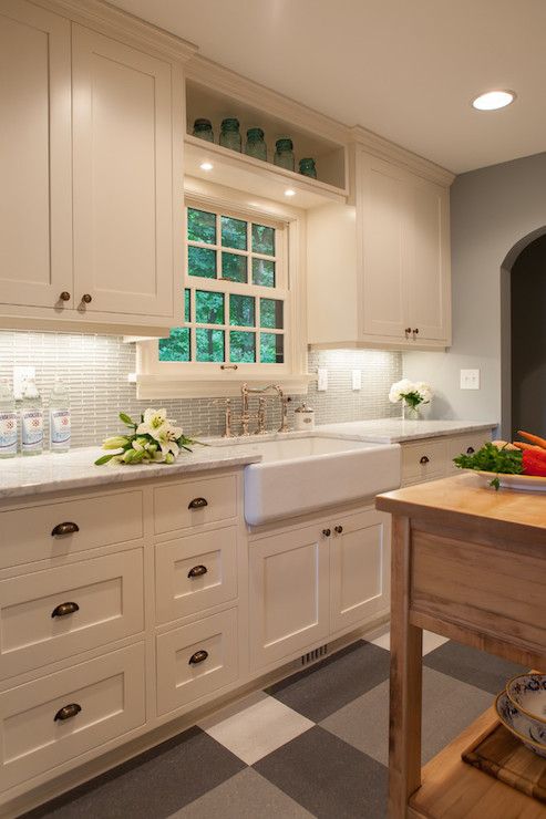 Gorgeous gray and ivory kitchen features white cabinets