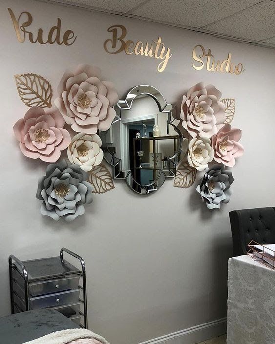 a room with flowers on the wall and mirrors above it that says ride beauty studio