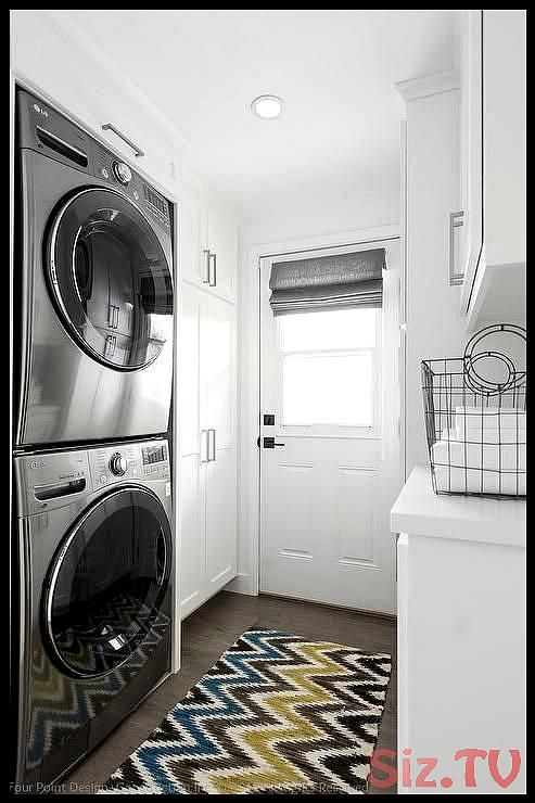 Small White Laundry Room Features Floor To Ceiling Cabinets Placed Next A Stacked Washer And Waschküchenorganisation Waschküchendesign Waschküchen Schränke Small White Laundry Room Features Floor, White Wall Cabinets For Laundry Room