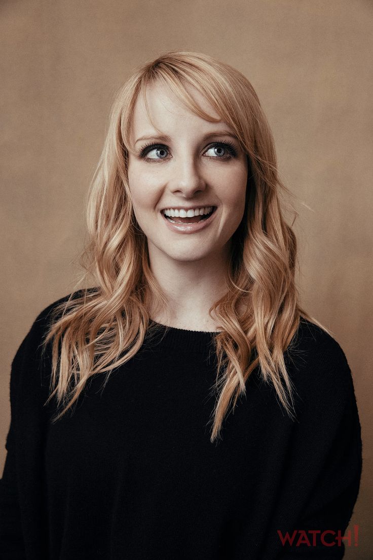 a woman with long blonde hair and blue eyes smiling at the camera while ...