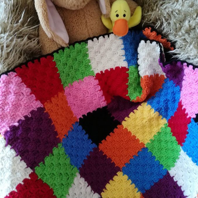 Handmade multi coloured patchwork crocheted baby blanket