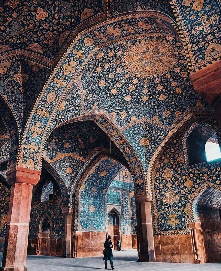 a person standing in an ornately decorated building