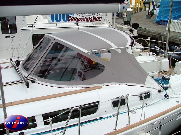 a white boat docked at a dock with other boats