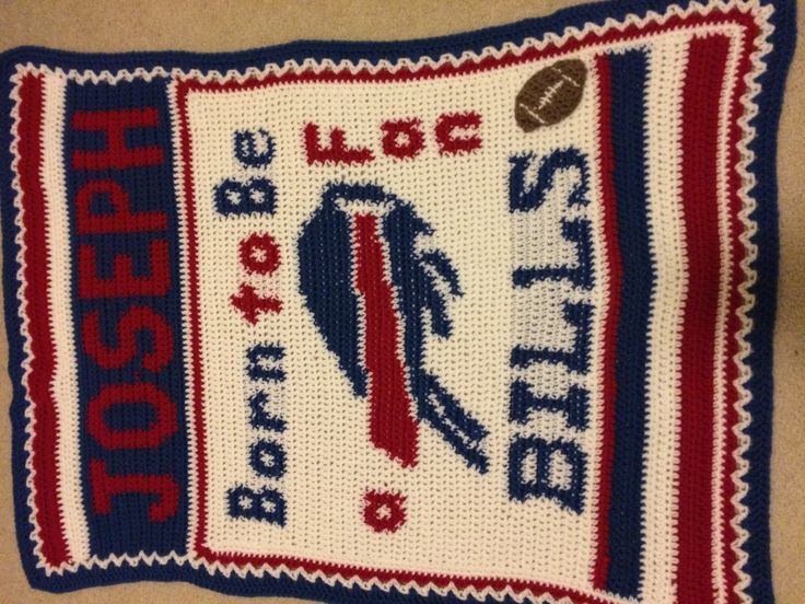 a crocheted pillow with an american football design on the front and