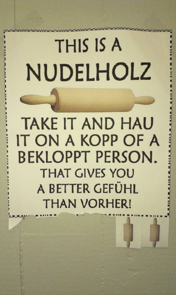 a sign on the wall that says, this is a nudelholz take it and hau it on a kop of a belopt person that gives you a better gefu than vorh