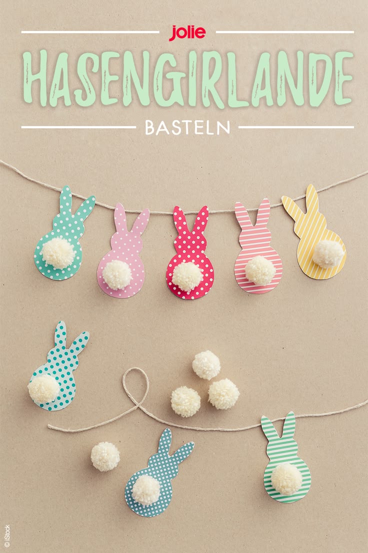 an easter bunting banner made with paper and pom poms on a string