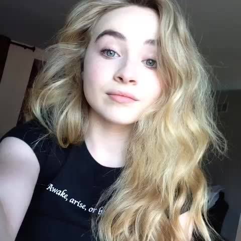 a woman with long blonde hair is taking a selfie in front of the camera