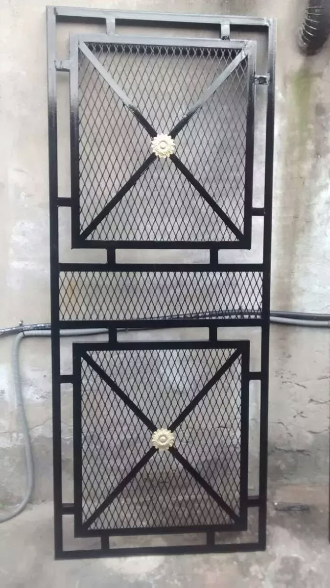 two metal boxes sitting next to each other on top of a cement floor in front of a wall