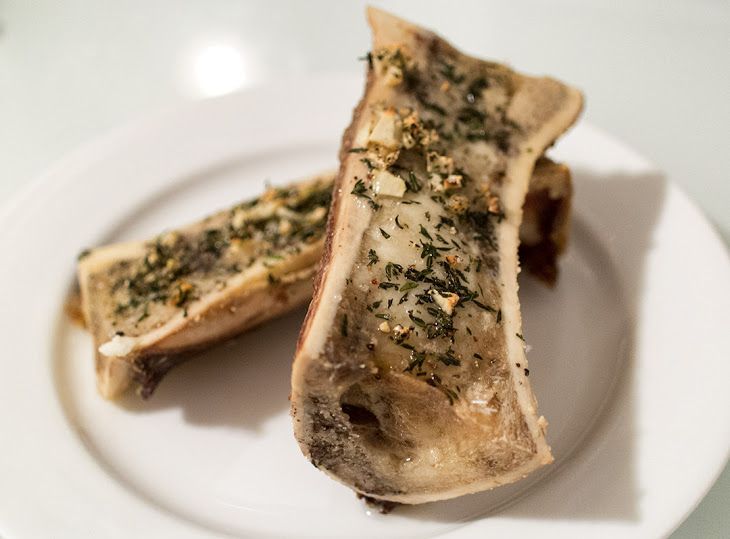 Two Pieces Of Fish On A Plate With Seasoning Sprinkled On It s Side