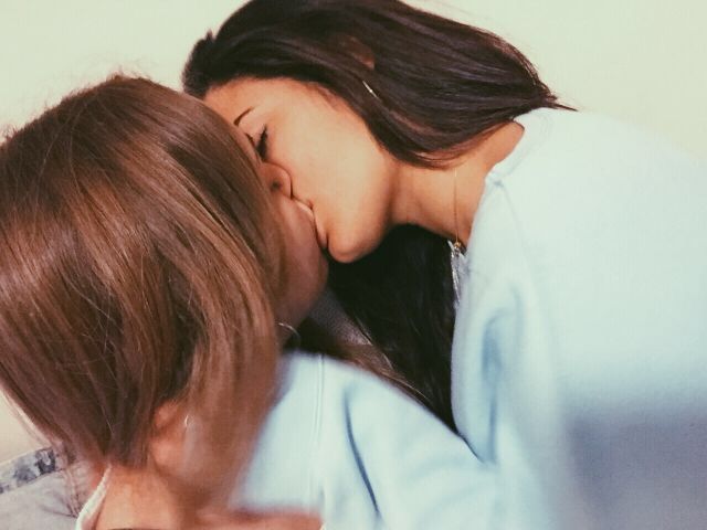 Model kissing girlfriend solo