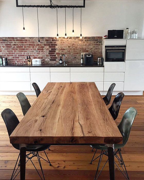 a wooden table sitting in the middle of a kitchen