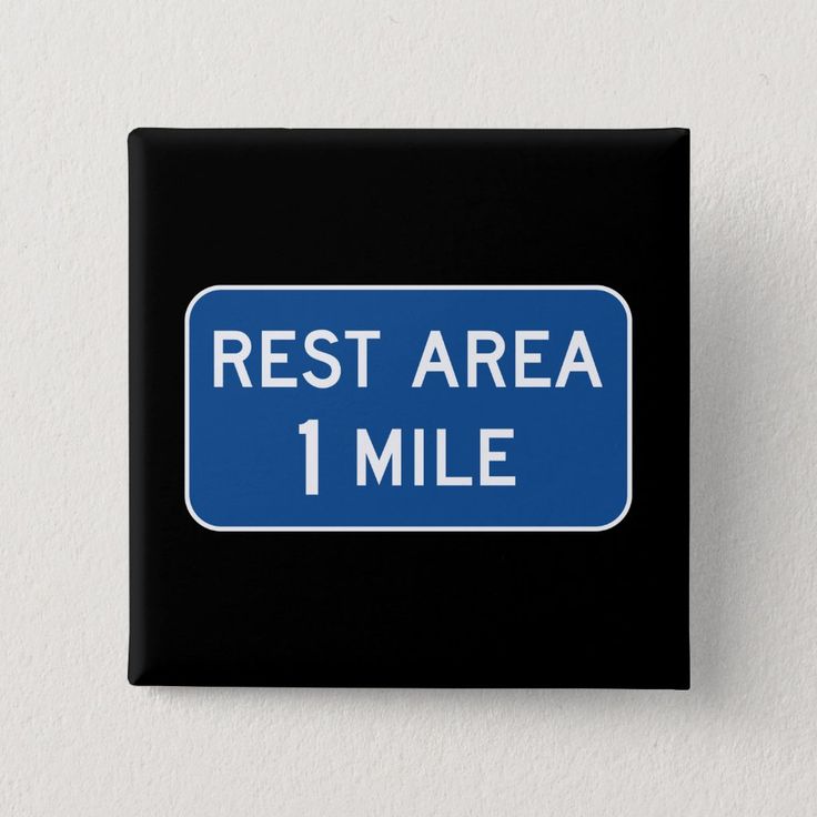 A Blue And White Sign That Says Rest Area 1 Mile a-blue-and-white-sign-that-says-rest-area-1-mile