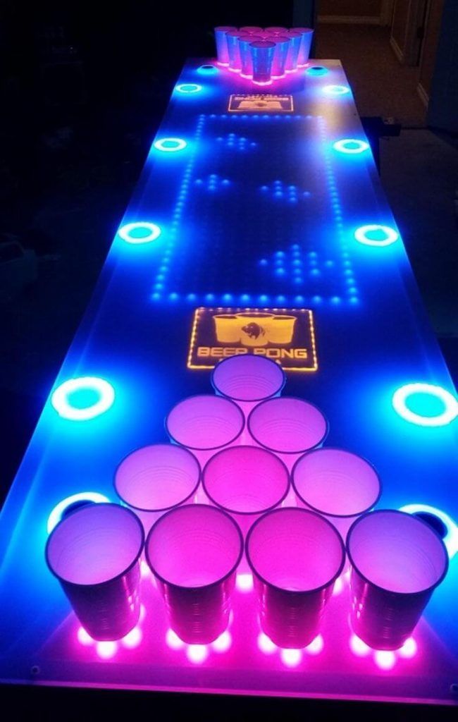 An Illuminated Table With Cups On It And Neon Lights At The Top Along An Illuminated Table With Cups On It And Neon Lights At The Top Along