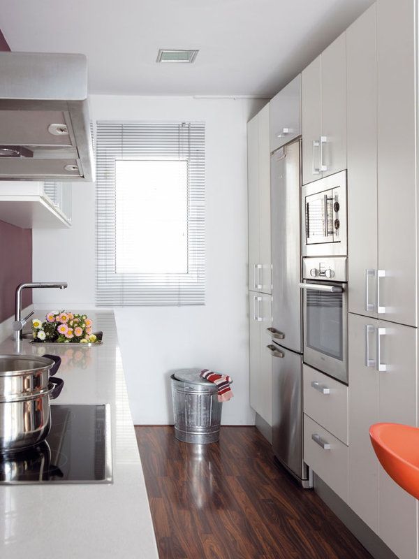 a modern kitchen with stainless steel appliances and wood flooring