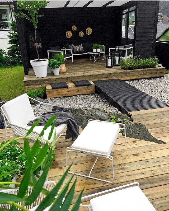 an image of a deck with chairs and plants in the back yard, on instagram