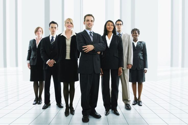 a group of business people standing next to each other