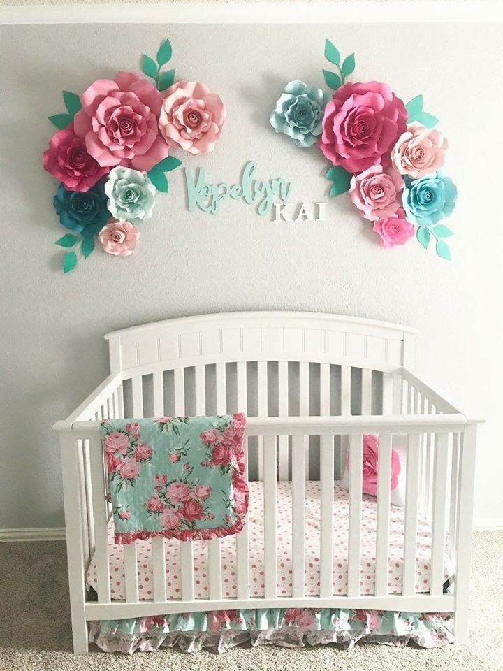 the baby crib is decorated with pink and blue flowers