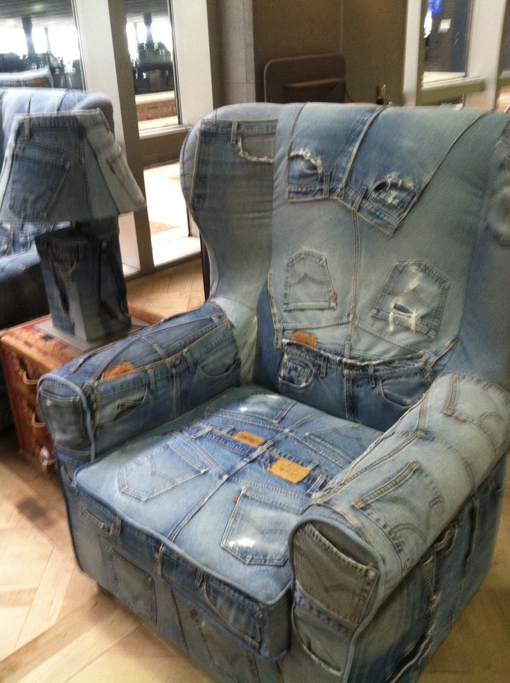 a chair made out of jeans sitting on top of a hard wood floor