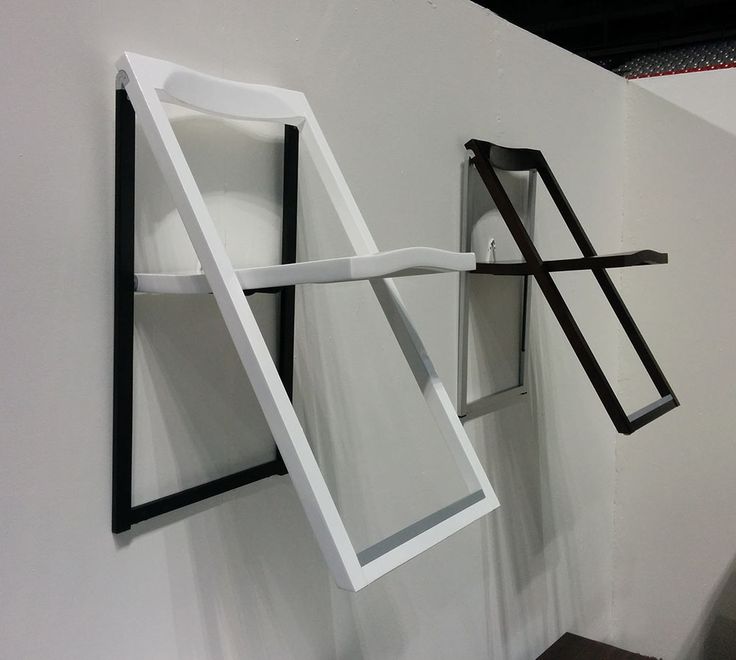 a white wall with some black and white objects hanging on it's side,