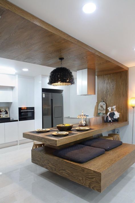 a modern kitchen with white walls and wood accents on the countertop, along with an island bench