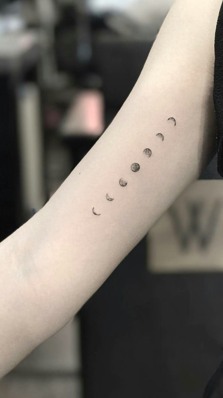 a person with a tattoo on their arm that says, phases of the moon tattoo i tumbr