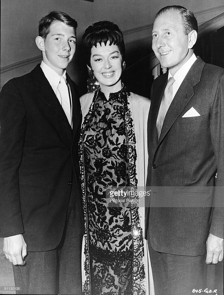 Rosalind Russell stands between her son, Lance Brisson (left) and her husband, stage and screen