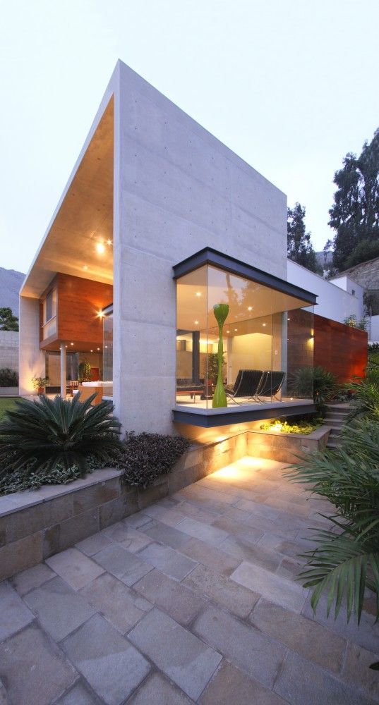 a modern house is lit up at night