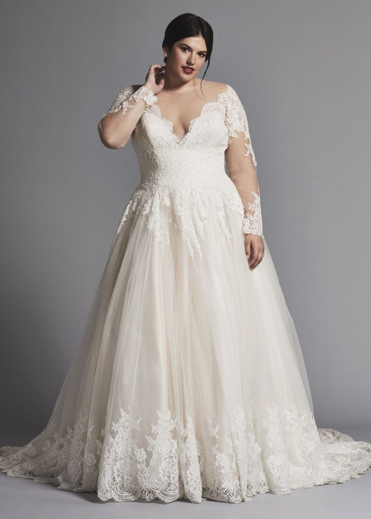 a woman in a wedding dress posing for the camera