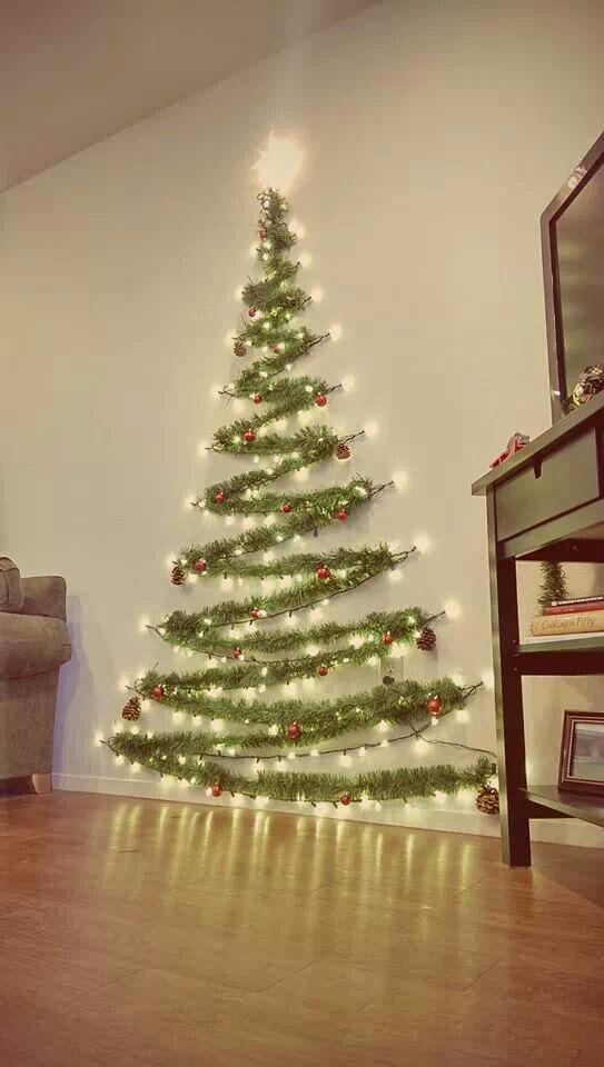 a living room with a christmas tree on the wall