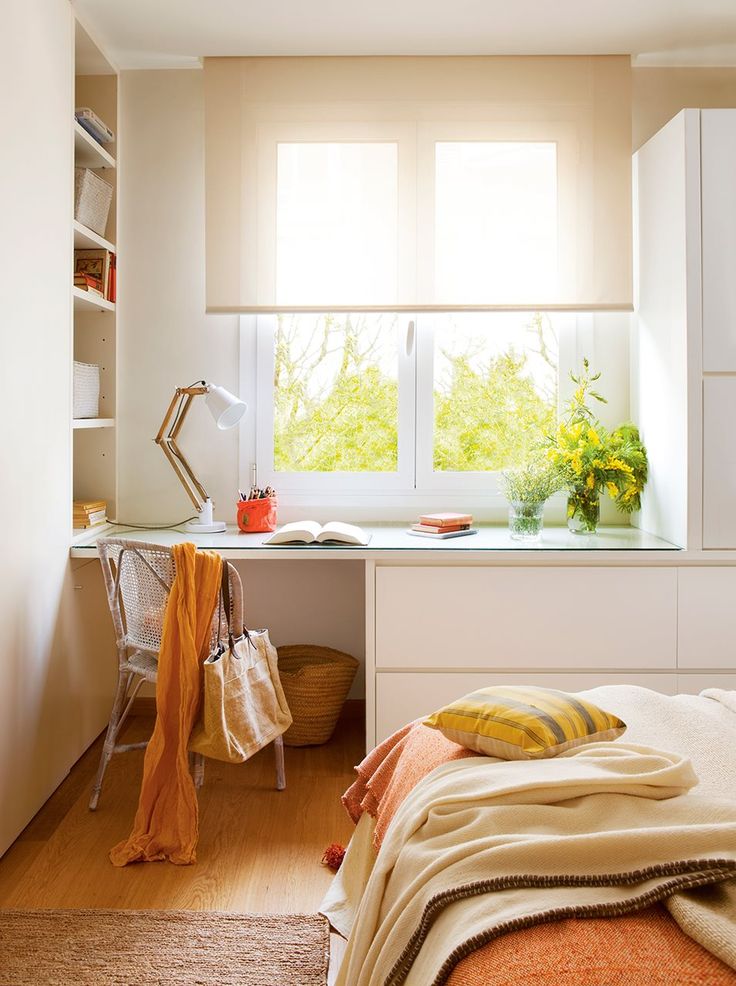 a bedroom with a bed, desk and window in it's centerpieces