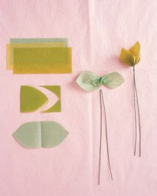 Double Leaf To make three double leaves, stack tissue in three hues of green. Cut 2-by-3-inch rectangles through all layers; fold in half. Trim tips into points; unfold. Twist each sheet at center. Fold 18-inch floral wire in half, slip over center of leaf, and twist. Fold tips toward each other, and curl.